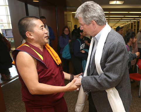Photo of an XU Faculty member shaking hands with a Religious leader