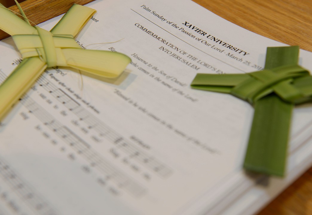 Crosses folded from palm leaves on top of sheet music