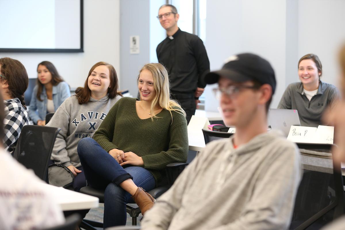 Photo of Students in Class with a Priest