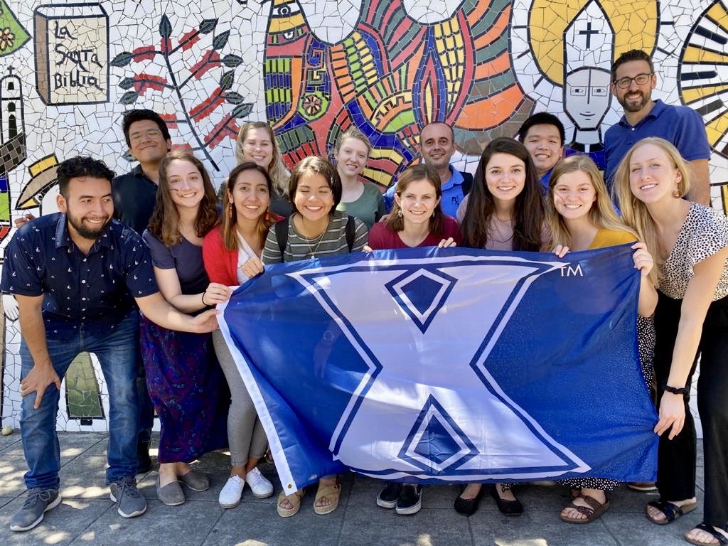 A group of Xavier University students gather with UCA students outside the home of Saint Óscar Romero in El Salvador in March 2020.