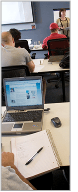 Students working on laptops in a classroom