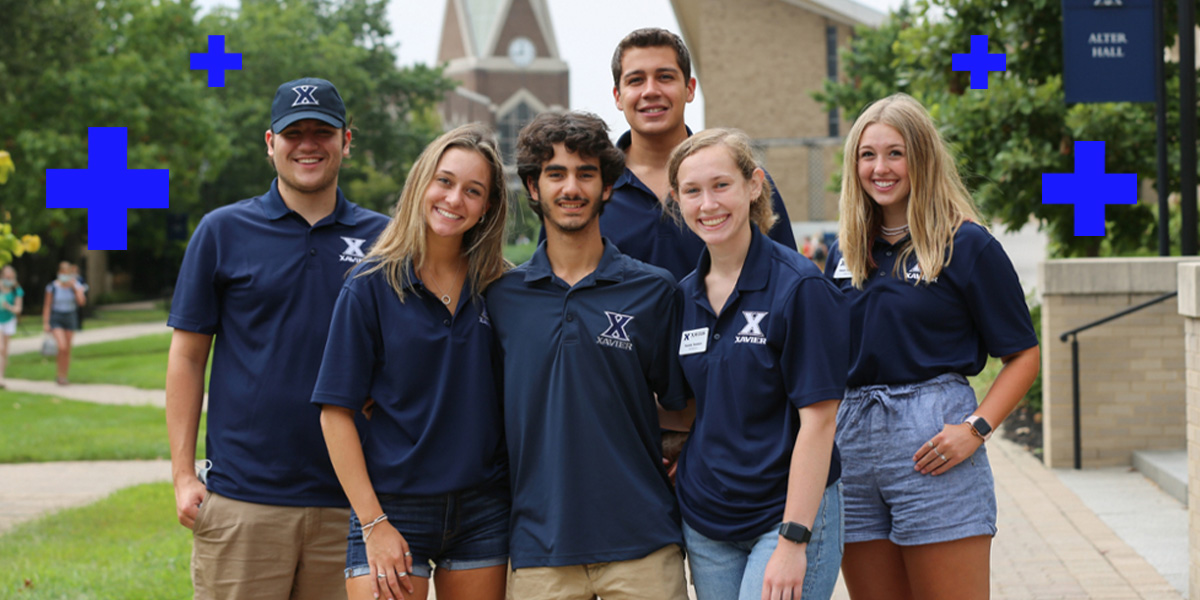 Six Xavier tour guides smiling in a group outside Alter Hall