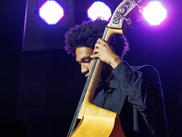 Student playing a bass onstage