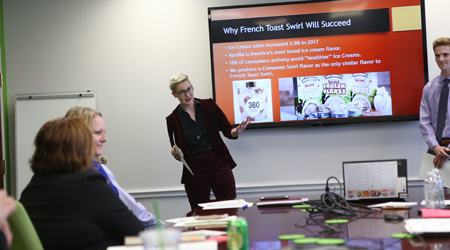 Two people presenting in a meeting room